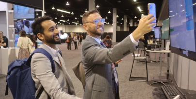 Two males, smiling toward presentation screen at ONS Congress 2022